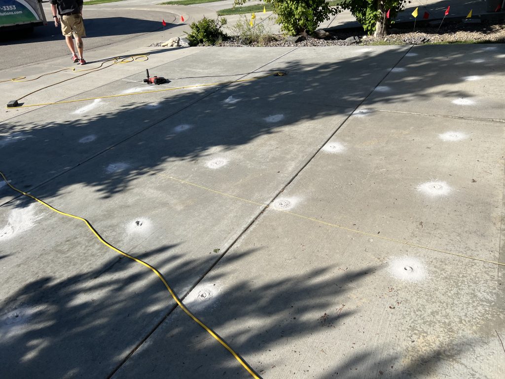 Small holes are drilled through the concrete.